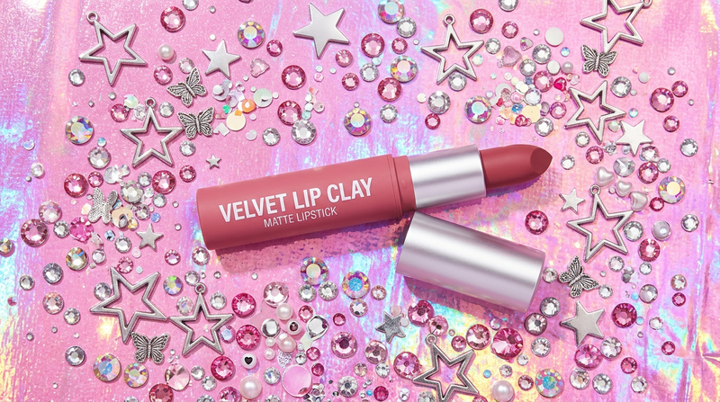 Velvet Lip Clay matte lipstick tube flat lay Y2K holographic foil aesthetic