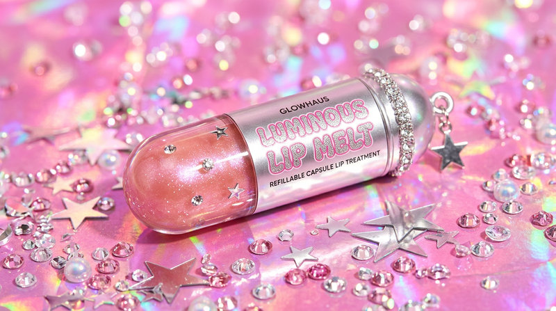 Luminous Lip Melt capsule product on bubblegum pink holographic background with pearl iridescent glow, rhinestone crystals and silver star decorations - Y2K beauty product photography