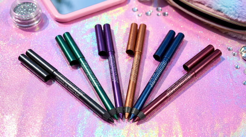 Six chromatic gel eyeliner pencils in multiple shades arranged in a fan on holographic pink surface