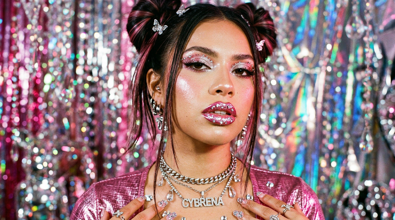 Cybrena Y2K beauty editorial mood shot with perfect defined lips, pink and chrome holographic aesthetic, rhinestone crystal bokeh