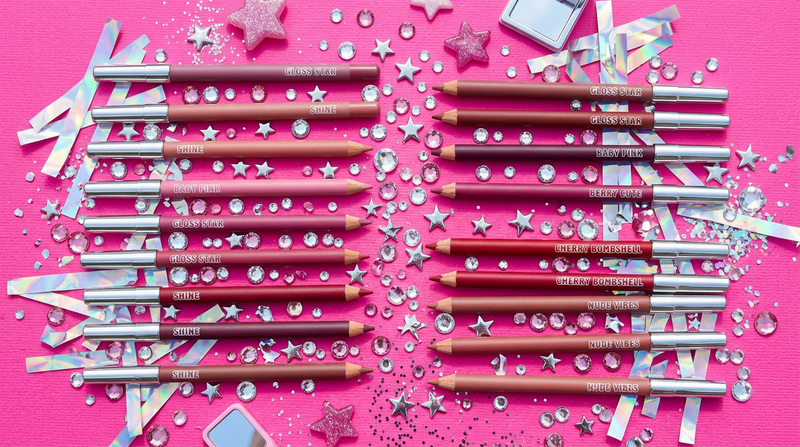 Lip liner pencils flat lay with crystal rhinestones and silver star charms - Y2K styling