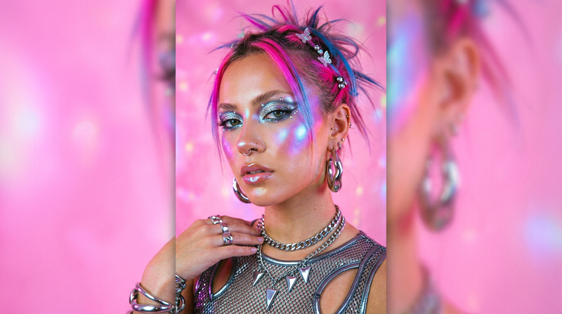 Model with prismatic holographic highlighted cheekbones Y2K futuristic makeup look