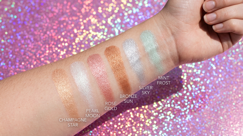 Six highlighter shades swatches on arm, champagne star pearl moon rose gold bronze silver mint frost
