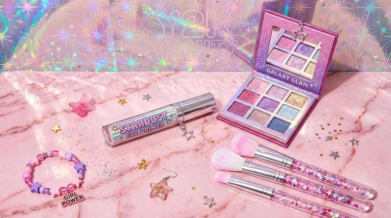 Eye primer base on pink marble with eyeshadow palette, brushes, holographic backdrop, star charms, Cybrena