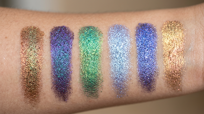 Close-up macro swatches of 6 eyeshadow pans - cosmic bronze mystic purple aurora green lunar lavender