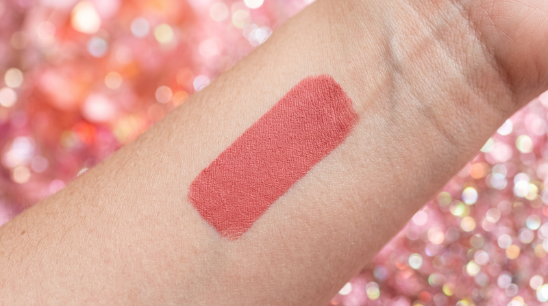 Close-up velvet matte lip color swatch on skin powder finish texture detail