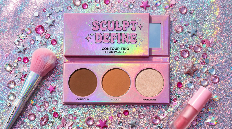 Sculpt and Define Trio 3-pan contour palette flat lay on holographic pink-silver background with rhinestone crystals and star charms - Cybrena Y2K